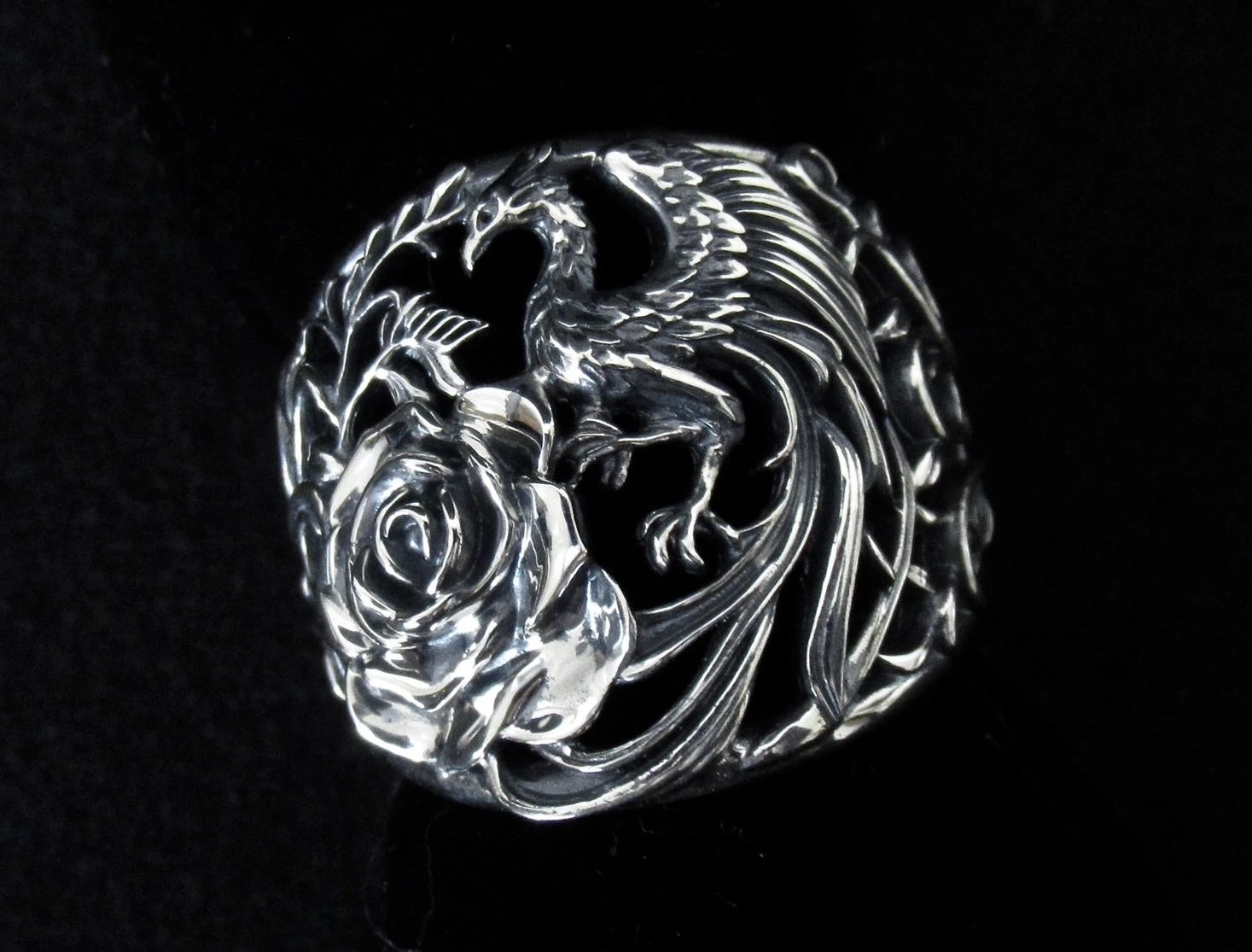 Phoenix with open wings beside the rose, showing individual feather details