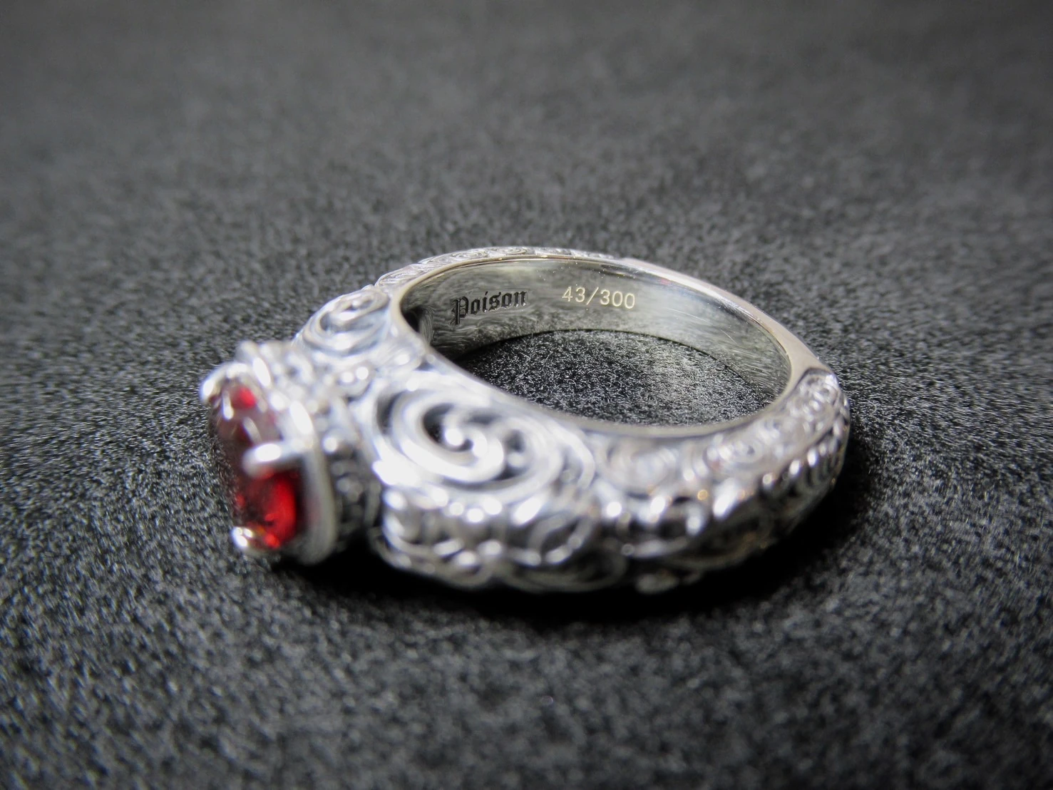 The unique serial number 43/300 engraved inside a POISON ring